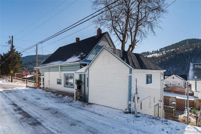 view of snow covered exterior with a mountain view