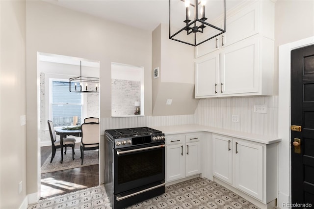 kitchen with white cabinetry, a chandelier, gas stove, and hanging light fixtures