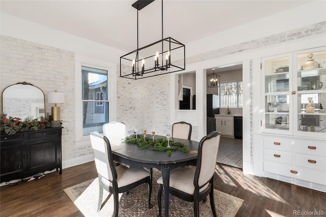 dining room featuring dark wood-type flooring and a notable chandelier