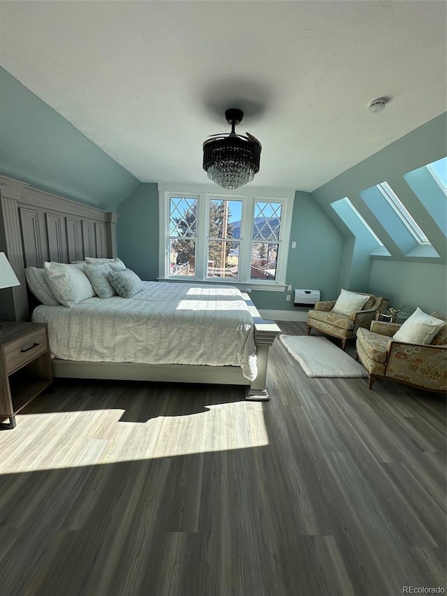 bedroom featuring dark wood-type flooring and lofted ceiling with skylight