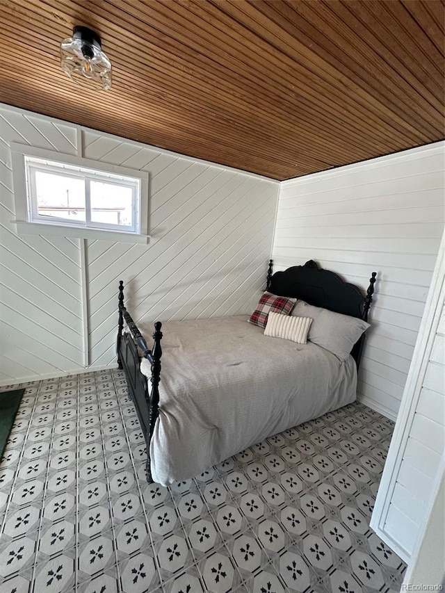 bedroom featuring wood ceiling and wood walls