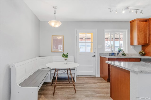 dining room with breakfast area, sink, and light hardwood / wood-style flooring