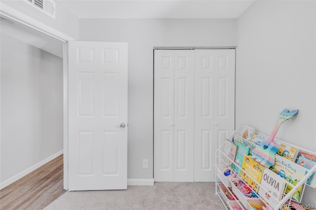 recreation room featuring baseboards and visible vents