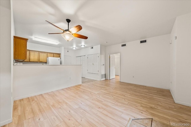 202 Lucca Dr, Evans, CO 80620 - unfurnished living room featuring ceiling fan, light wood-style flooring, and baseboards