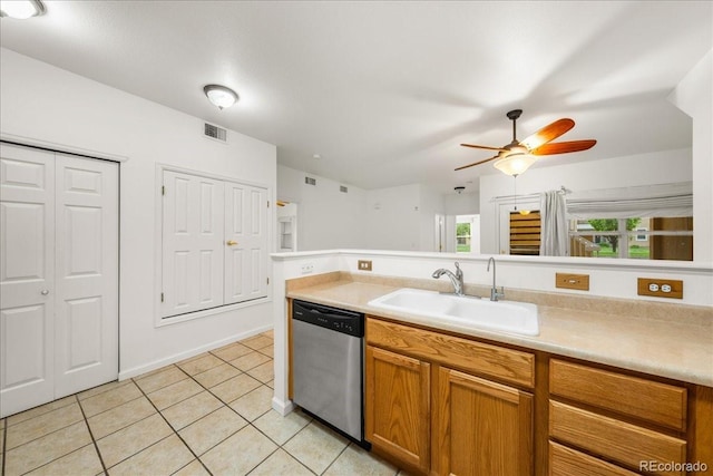 202 Lucca Dr, Evans, CO 80620 - kitchen featuring stainless steel dishwasher, a sink, light tile patterned floors, light countertops, and brown cabinets