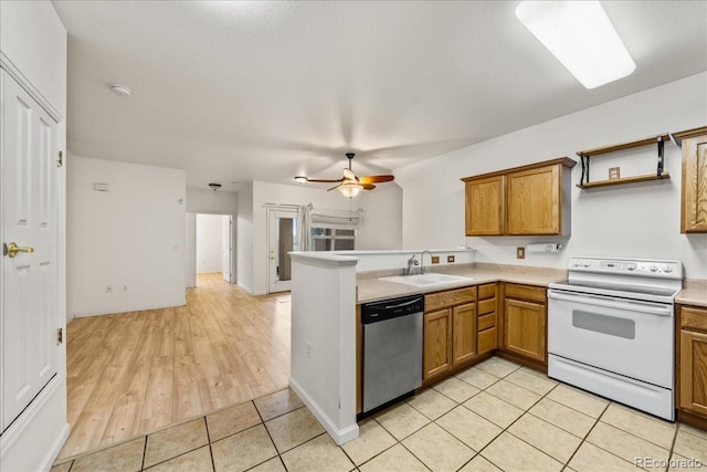 202 Lucca Dr, Evans, CO 80620 - kitchen with white electric stove, dishwasher, a sink, brown cabinetry, and a peninsula