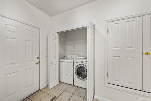 202 Lucca Dr, Evans, CO 80620 - laundry area with washer and dryer, light tile patterned floors, and baseboards