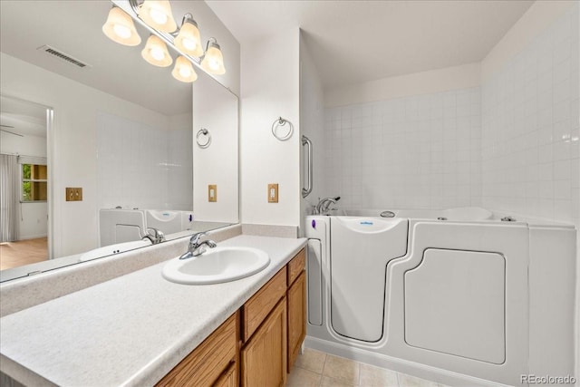 202 Lucca Dr, Evans, CO 80620 - full bathroom with vanity, a garden tub, and tile patterned floors