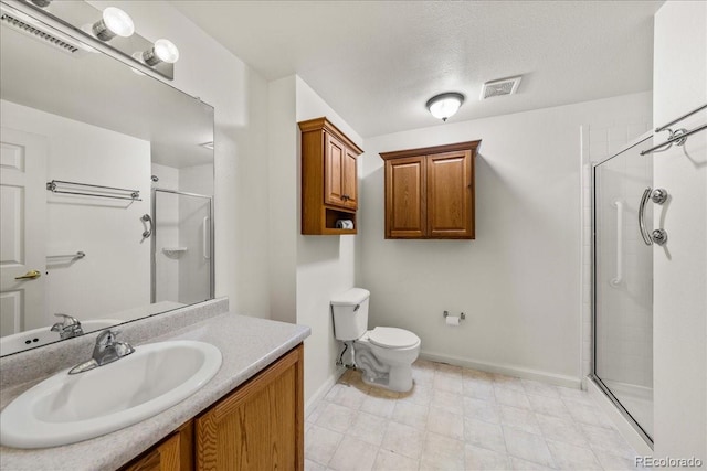 202 Lucca Dr, Evans, CO 80620 - bathroom featuring a shower stall, vanity, baseboards, toilet, and a textured ceiling