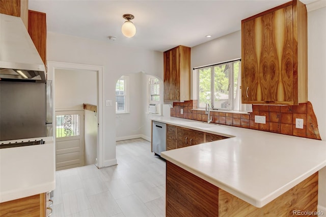 2636 N Glencoe St, Denver, CO 80207 - kitchen featuring a sink, stainless steel dishwasher, custom range hood, arched walkways, and backsplash
