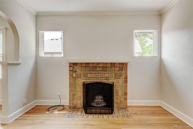 2636 N Glencoe St, Denver, CO 80207 - detailed view of a fireplace, wood finished floors, ornamental molding, baseboards, and arched walkways