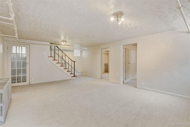 2636 N Glencoe St, Denver, CO 80207 - below grade area with a textured ceiling, stairway, light colored carpet, and baseboards