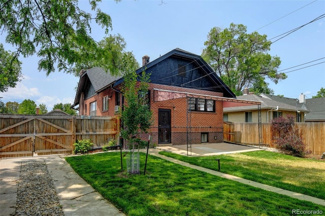 2636 N Glencoe St, Denver, CO 80207 - back of property featuring brick siding, a patio, a gate, and a chimney