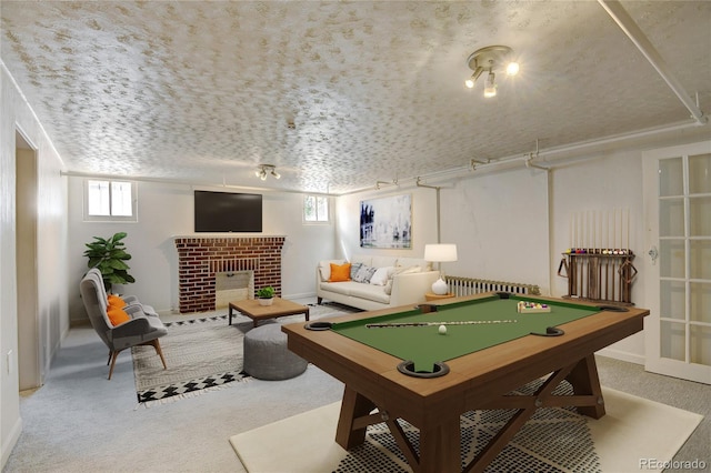2636 N Glencoe St, Denver, CO 80207 - recreation room with carpet, billiards table, a brick fireplace, and radiator heating unit