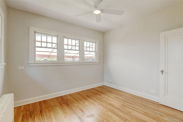 2636 N Glencoe St, Denver, CO 80207 - empty room featuring radiator, baseboards, wood finished floors, and a ceiling fan