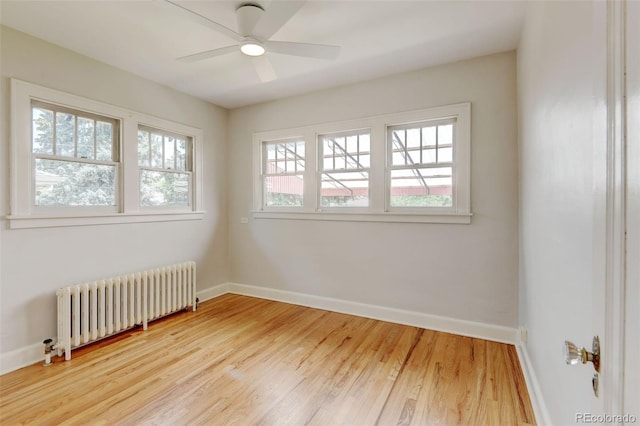 2636 N Glencoe St, Denver, CO 80207 - empty room with radiator, baseboards, wood finished floors, and a ceiling fan