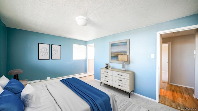 carpeted bedroom featuring a textured ceiling