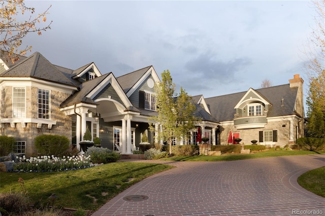 5470 S Highline Cir, Greenwood Village, CO 80121 - french country inspired facade with curved driveway, a chimney, and stone siding