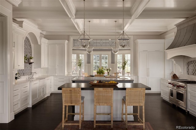 5470 S Highline Cir, Greenwood Village, CO 80121 - kitchen with range with two ovens, a kitchen island, plenty of natural light, decorative backsplash, and coffered ceiling