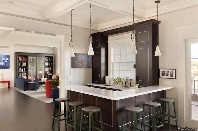 5470 S Highline Cir, Greenwood Village, CO 80121 - kitchen featuring light countertops, a breakfast bar, dark brown cabinetry, crown molding, and beamed ceiling