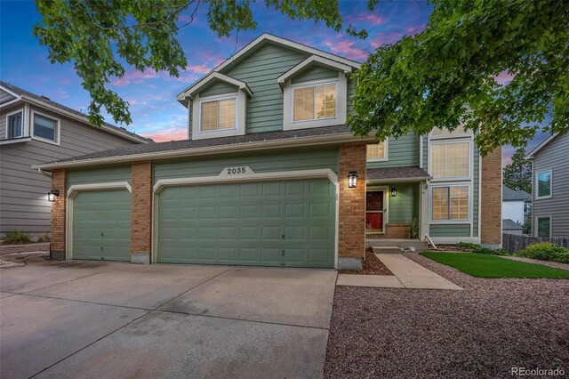 2035 Springcrest Rd, Colorado Springs, CO 80920 - view of front of house with brick siding, concrete driveway, and a garage