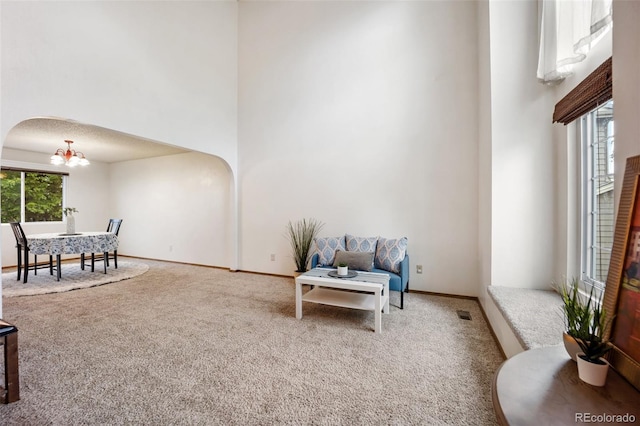 2035 Springcrest Rd, Colorado Springs, CO 80920 - sitting room with carpet, arched walkways, a high ceiling, and a chandelier