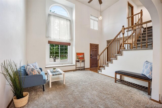 2035 Springcrest Rd, Colorado Springs, CO 80920 - foyer entrance with stairs, a towering ceiling, arched walkways, carpet flooring, and a ceiling fan