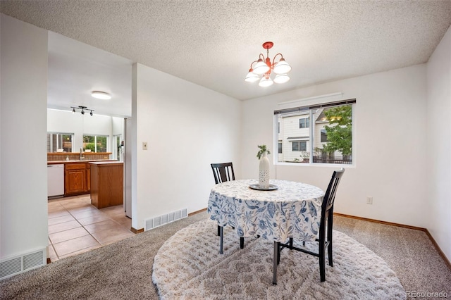 2035 Springcrest Rd, Colorado Springs, CO 80920 - dining room with light colored carpet, a chandelier, and a textured ceiling
