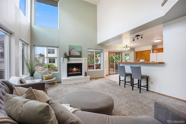 2035 Springcrest Rd, Colorado Springs, CO 80920 - living room with a high ceiling, light carpet, and a brick fireplace