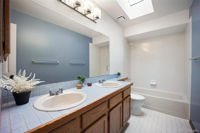 2035 Springcrest Rd, Colorado Springs, CO 80920 - full bath featuring a skylight, double vanity, tasteful backsplash, bathing tub / shower combination, and tile patterned floors