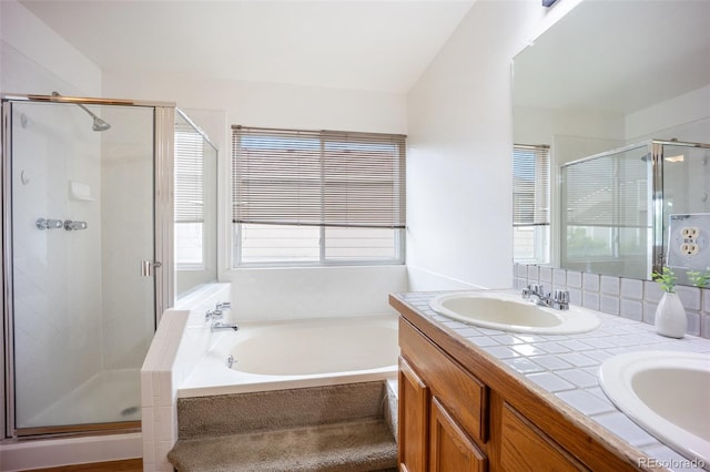 2035 Springcrest Rd, Colorado Springs, CO 80920 - full bath with healthy amount of natural light, a shower stall, a bath, and double vanity