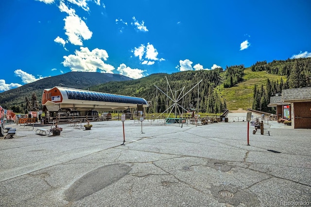 view of home's community with a mountain view and an outbuilding