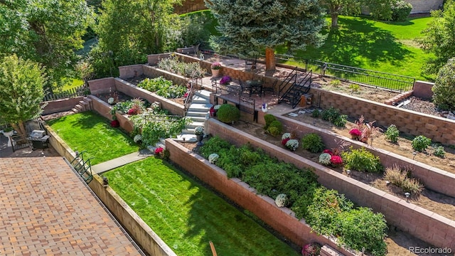 exterior space with a vegetable garden and fence