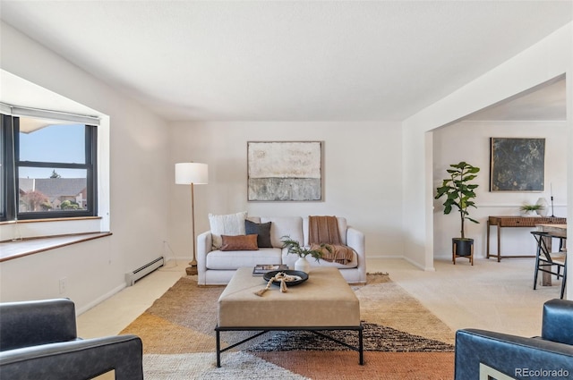 living room featuring a baseboard radiator, baseboards, and carpet