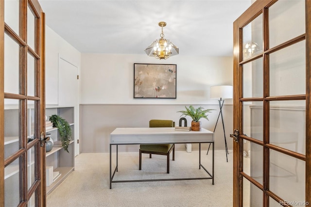 office space featuring french doors, a notable chandelier, and carpet flooring