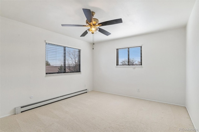 carpeted spare room with a baseboard heating unit and ceiling fan