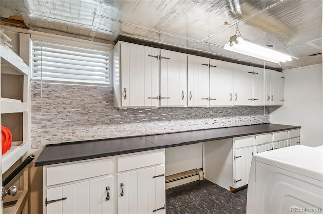 kitchen featuring a baseboard radiator, washer / dryer, decorative backsplash, white cabinets, and dark countertops