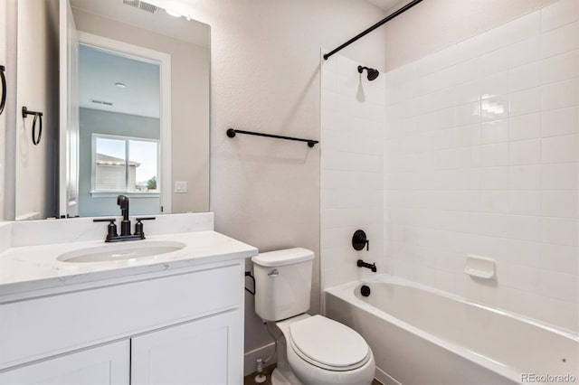 full bath featuring toilet, a textured wall, vanity, and shower / bathtub combination