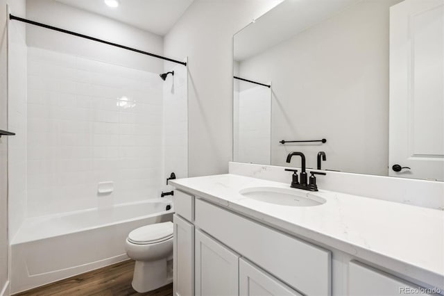 full bathroom featuring toilet, shower / washtub combination, wood finished floors, and vanity