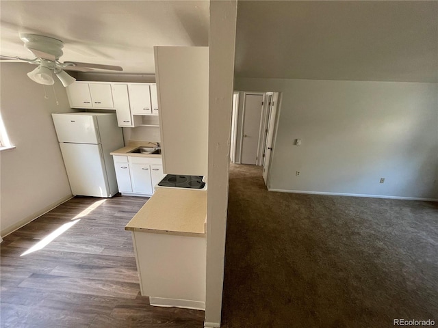 3760 Owens St, Wheat Ridge, CO 80033 - kitchen with freestanding refrigerator, a ceiling fan, light countertops, and white cabinets