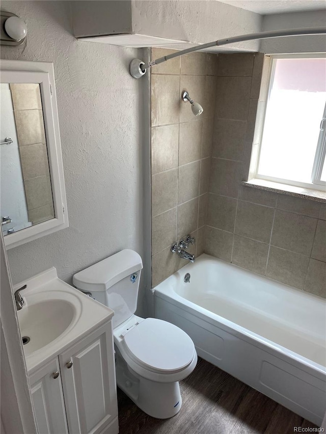 3760 Owens St, Wheat Ridge, CO 80033 - full bath featuring a textured wall, toilet, wood finished floors, shower / washtub combination, and vanity