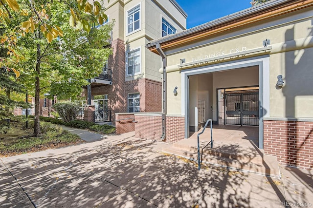 exterior space with brick siding and stucco siding