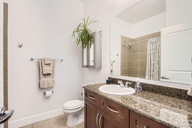 full bath featuring vanity, baseboards, tiled shower, tile patterned flooring, and toilet