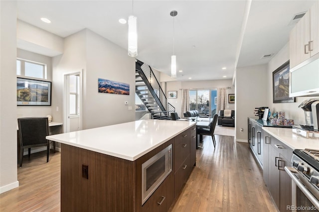 kitchen featuring stainless steel appliances, modern cabinets, and a kitchen island