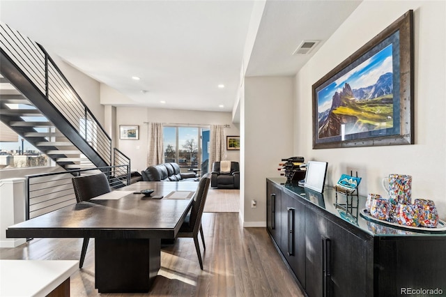 dining space with baseboards, visible vents, wood finished floors, stairs, and recessed lighting