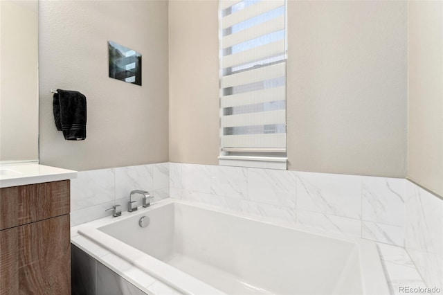 full bath with a garden tub and vanity