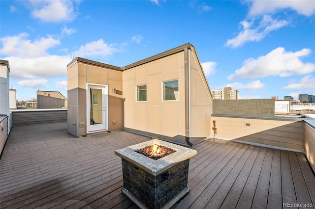 wooden deck with an outdoor fire pit