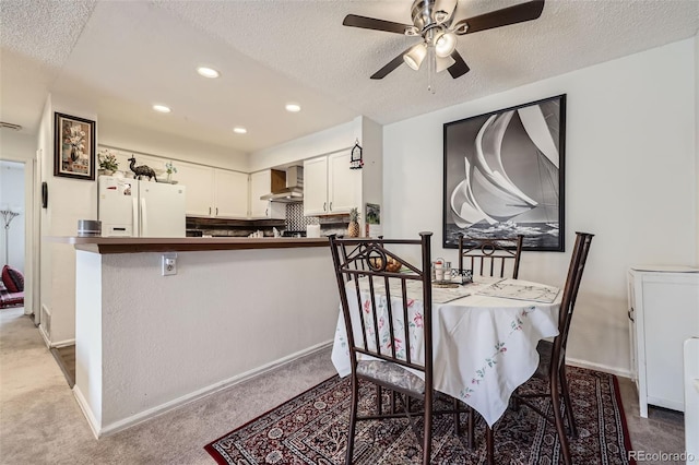 dining room with recessed lighting, carpet flooring, ceiling fan, and a textured ceiling