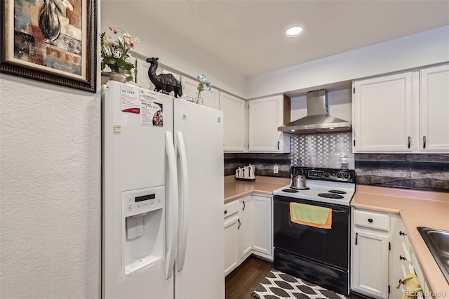kitchen with white fridge with ice dispenser, electric range, white cabinets, backsplash, and wall chimney range hood