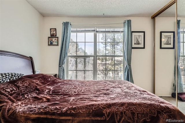 carpeted bedroom featuring a textured ceiling